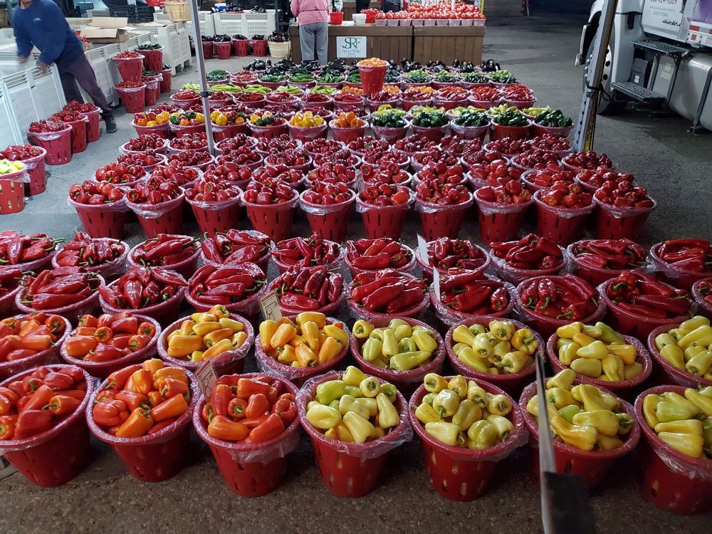 Buckets of farm fresh red, orange and yellow pepper at St Jacobs market from Spruce Ridge Farm in Rodney, Ontario.